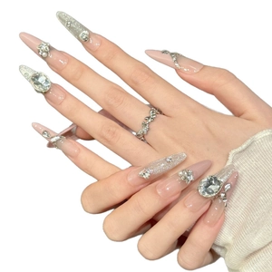 Luxurious pink press-on nails with glitter gradient and 3D crystal floral jewelry