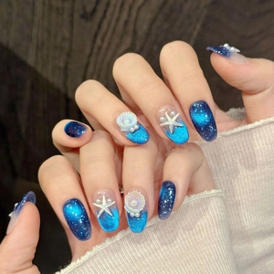 Blue ocean-themed handmade press-on nails with 3D starfish and shell charms
