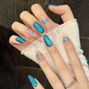 Blue cat eye press-on nails with laser butterfly designs and shimmering gradient finish