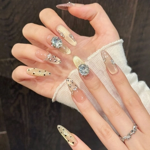 Champagne gold cat eye press-on nails with rhinestones and elegant pearls on long almond shape