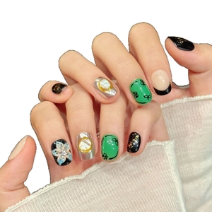 Artistic short square press-on nails with 3D floral, pearl, and bow tie designs