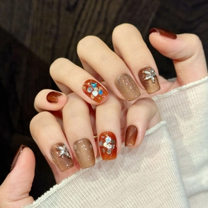 Handmade brown gradient cat-eye press-on nails with sparkling rhinestones and floral accents