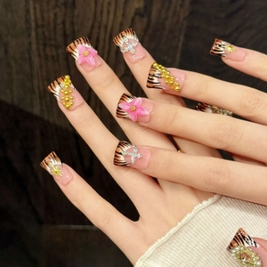 Handmade tiger print press-on nails with 3D pink flowers and Y2K metallic charms