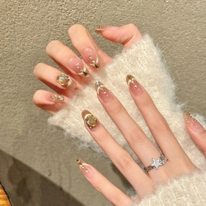 Elegant gradient nude pink press-on nails with amber rhinestones and gold glitter details