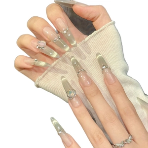 Green to nude gradient press-on nails with cat-eye glitter and metal chain charms