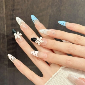 Blue and white bow press-on nails with heart charms and floral 3D accents
