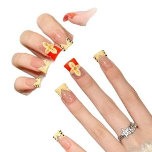 Pink and orange press-on nails with tiger stripes and 3D embossed floral patterns