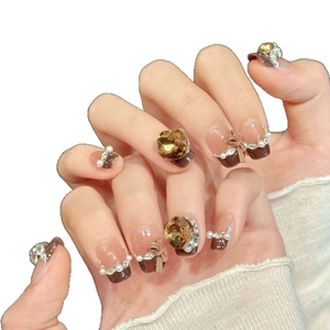 Brown and pink gradient press-on nails with luxury bows, pearls and amber rhinestones