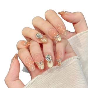 Luxury pink gradient press-on nails with golden glitter, pearls and zircon crystals