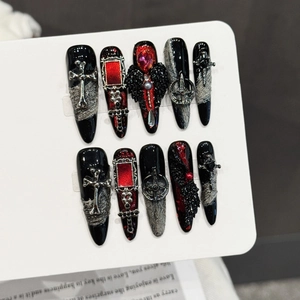 Gothic black and red press-on nails with silver crosses and red gemstones