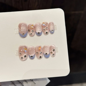 Pink and blue gradient press-on nails with cat eye effect and sparkling star rhinestones