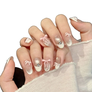 Pink gradient bow press-on nails with champagne cat-eye glitter and rhinestones