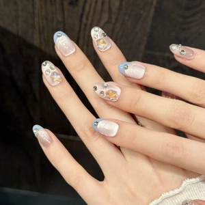 Handmade pink and blue gradient press-on nails with shiny stars and rhinestone accents