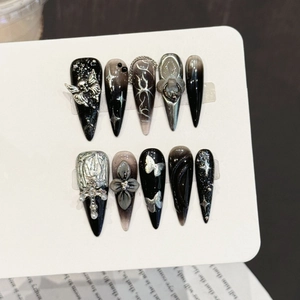 Handmade stiletto nails with gothic skull, silver chains, and 3D floral accents in black