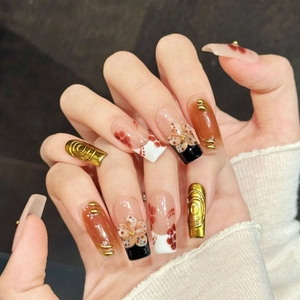 Retro handmade press-on nails with floral patterns, gold embossed textures and amber finish