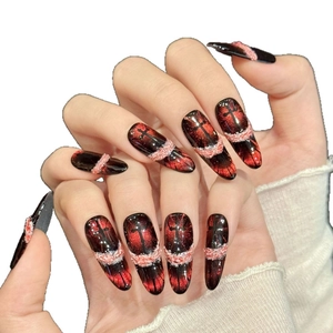 Black and red gradient cat-eye press-on nails with cross charms and stiletto shape