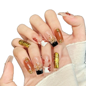 Handmade press-on nails featuring pink floral patterns and gold embossed vintage textures