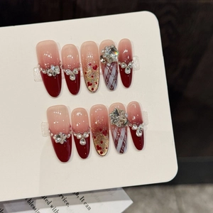 Unghie finte francesi rosso vino con cuori, pois e strass di lusso dall'effetto velluto