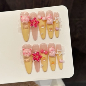Pink and yellow gradient press-on nails with 3D pig, star, and pearl decorations