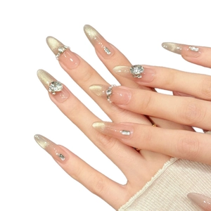 Handmade gold cat-eye press-on nails with sparkling rhinestones and pearl accents
