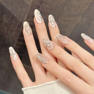Elegant gradient nude pink press-on nails with sparkling rhinestones and glitter finish