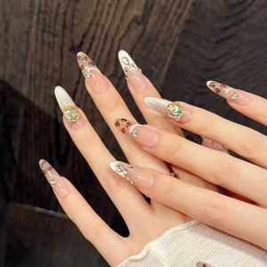 Handmade almond press-on nails with amber cat-eye finish and luxury gemstone accents