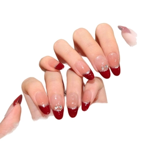 Handmade burgundy French press-on nails with silver bow charms and nude gradient finish