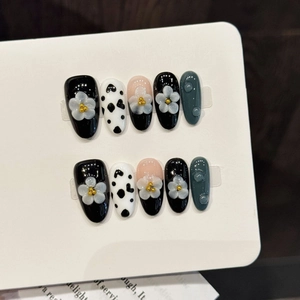 Handmade cow print press-on nails with 3D floral accents and water droplet texture