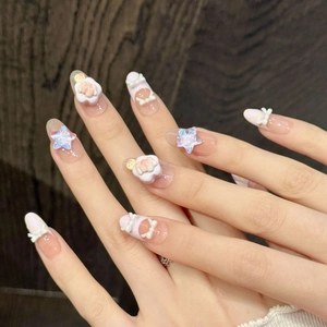 Pink and purple handmade press-on nails with star, bow, and bear decorations