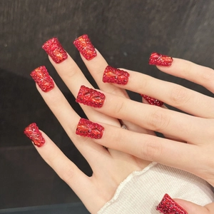 Luxurious long square press-on nails in deep red with sparkling crystals and gems