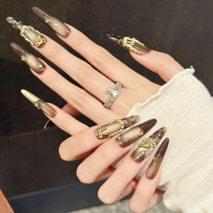 Brown and gold cat eye press-on nails with 3D bow and stiletto shape for women