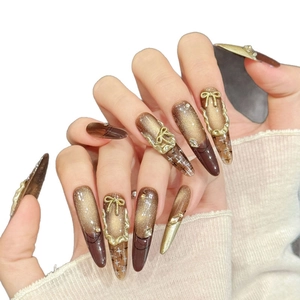 Brown and gold cat-eye press-on nails with 3D bows and star patterns for women