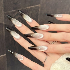 Long stiletto press-on nails with black silver cat-eye magnetic gradient and glitter