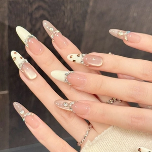 Pink leopard print press-on nails with almond shape, cat eye effect, and sparkling rhinestones
