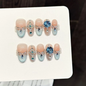 Handmade press-on nails with blue-pink gradient, luxury rhinestones, and cat-eye finish