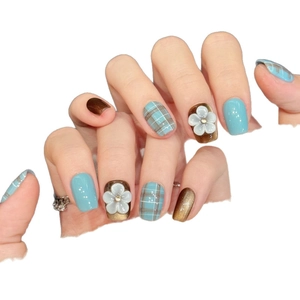 Handmade press-on nails featuring blue and brown plaid patterns and 3D floral accents