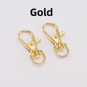 Detailed view of two polished gold lobster clasps with 360-degree rotating swivel rings