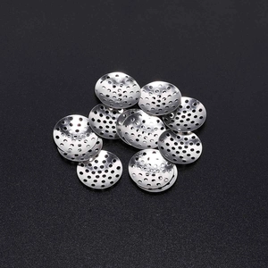 Stack of round stainless steel filter screens with perforated mesh and silver finish