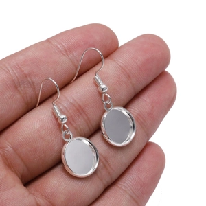 Macro shot of silver round bezel setting earring hooks for DIY jewelry crafting