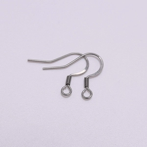 Detailed macro view of stainless steel fish hook earrings with spiral coil for DIY jewelry