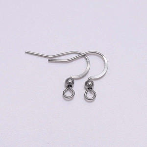 Close-up of stainless steel earring hooks with decorative beads for DIY jewelry making