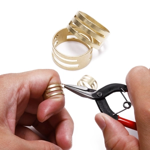 Adjustable brass ring tool for jump ring opening with matte gold finish on white background