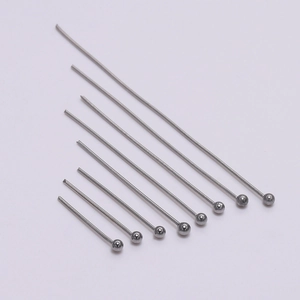 Detailed view of eight assorted lengths of stainless steel ball head pins for jewelry making