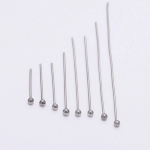 Close-up of polished stainless steel ball head pins in eight different lengths for DIY jewelry