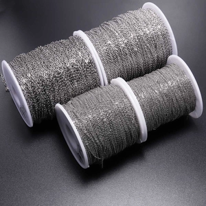 Flat O-shaped stainless steel link chains in three sizes on white spools for DIY jewelry making