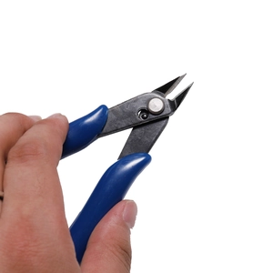 Close-up of industrial side cutters with blue non-slip handles for DIY jewelry making