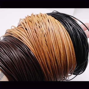 Close-up of high-quality round leather cords in black, dark brown, and tan for DIY jewelry