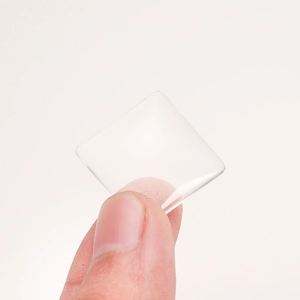 Square transparent glass cabochons for DIY jewelry making held to show size