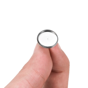 Base de boucles d'oreilles ronde en acier inoxydable DIY tenue entre les doigts