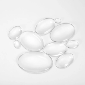 Close-up of clear oval glass cabochons with smooth surface for DIY jewelry making